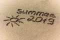 The word summer and sun written in the sand on a beach Royalty Free Stock Photo