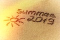 The word summer and sun written in the sand on a beach Royalty Free Stock Photo