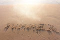 The word summer written in sea sand. Warm sunset time, vacation and enjoyment Royalty Free Stock Photo