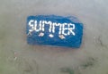 The word Summer written with sea shells on a stone under water Royalty Free Stock Photo