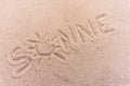 Word sun in german written on the sand of the beach Royalty Free Stock Photo