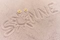 Word sun in german written on the sand of the beach Royalty Free Stock Photo