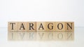 The word Taragon was created from wooden letter cubes. Gastronomy and spices. Royalty Free Stock Photo