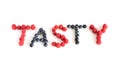 The word Tasty written with raspberries and blueberries