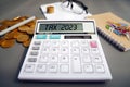 Word Tax 2023 on the calculator. Business and tax concept .Calculator, currency, book, tax form, and pen on gray desk table. Royalty Free Stock Photo