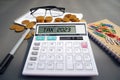 Word Tax 2023 on the calculator. Business and tax concept .Calculator, currency, book, tax form, and pen on gray desk table. Royalty Free Stock Photo