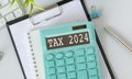 Word Tax 2024 on the calculator on documents.Income Statement. paying the tax rate. Taxation, taxes burden.Business and tax Royalty Free Stock Photo