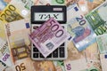 The word `tax` on a calculator scoreboard on a euro background.