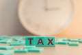 The word TAX made of small colorful game board pieces with letters imprinted on them. Financial research, government Royalty Free Stock Photo