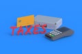 Word taxes near metal suitcase and cash register, plastic card on blue background Royalty Free Stock Photo