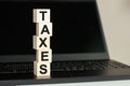 The word Taxes in wooden cubes on the keyboard