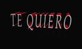 Word TE QUIERO written in a cool pretty font isolated on blackbackground