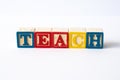 The word Teach spelled with toy blocks