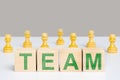 The word team on wooden cubes among chess pieces pawns Royalty Free Stock Photo