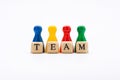 Word team on wooden blocks and pawns in various colors on white background Royalty Free Stock Photo