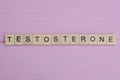 word testosterone from small gray wooden letters