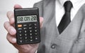 80 on 20 word text inscription on calculator in a male hand of a businessman in white shirt and blue tie, Concept of finance and Royalty Free Stock Photo