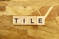 word Tile made of wooden blocks on osb background Royalty Free Stock Photo