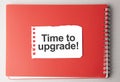 The word Time to upgrade on torn paper on red notepad Royalty Free Stock Photo