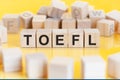 word TOEFL written on wood blocks, concept