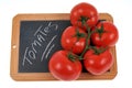 Tomatoes resting on a school slate