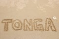 Word Tonga written in a sand