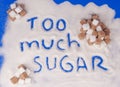 The word too much sugar written in sugar grains