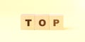 Word top with letters on wooden blocks on bright yellow Royalty Free Stock Photo