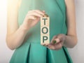 Word TOP on wooden cubes. Female hands holding cubes Royalty Free Stock Photo