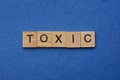 Word toxic made from brown wooden letters