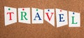 The word travel is standing on pinned paper, vacation in summertime, making an adventure trip