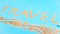 The word travel written on a bright blue background reminds the sea