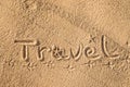 Word Travel written in the sand on the beach.  Summer travel concept. Birds footprints on yellow sand Royalty Free Stock Photo