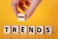 The word trend on wooden cubes, yellow background