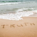 Word truth written on the sand