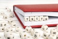 Word Truth written in wooden blocks in red notebook on white wo