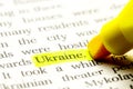 Word UKRAINE is select in yellow marker on paper