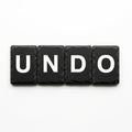 Undo Word Concept on Black Slate Tiles with White Copy Space Royalty Free Stock Photo