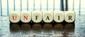 Word Unfair or fair inside dices Royalty Free Stock Photo