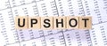 Word UPSHOT made with wood building blocks