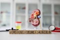 Word Urolithiasis made of cubes against model of kidney