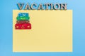 Word vacation abstract wooden letters. Background blue yellow, image of heap of suitcases