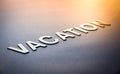 Word vacation written with white solid letters Royalty Free Stock Photo