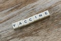 Word Vaccine alphabet on wooden background