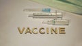 The word vaccine is laid out on a hundred table surrounded by an ampoule and syringe