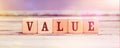 Word Value with wood cubes on table