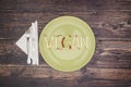 Word vegan on green dish Royalty Free Stock Photo