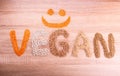 Word Vegan with a smile made of lentils, buckwheat, beans, rice