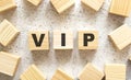 The word VIP consists of wooden cubes with letters, top view on a light background Royalty Free Stock Photo