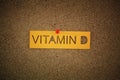 The word Vitamin D pinned to a cork board